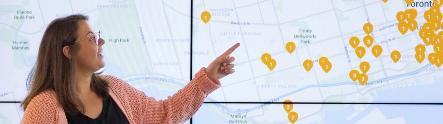 Employee presenting in front of a large screen