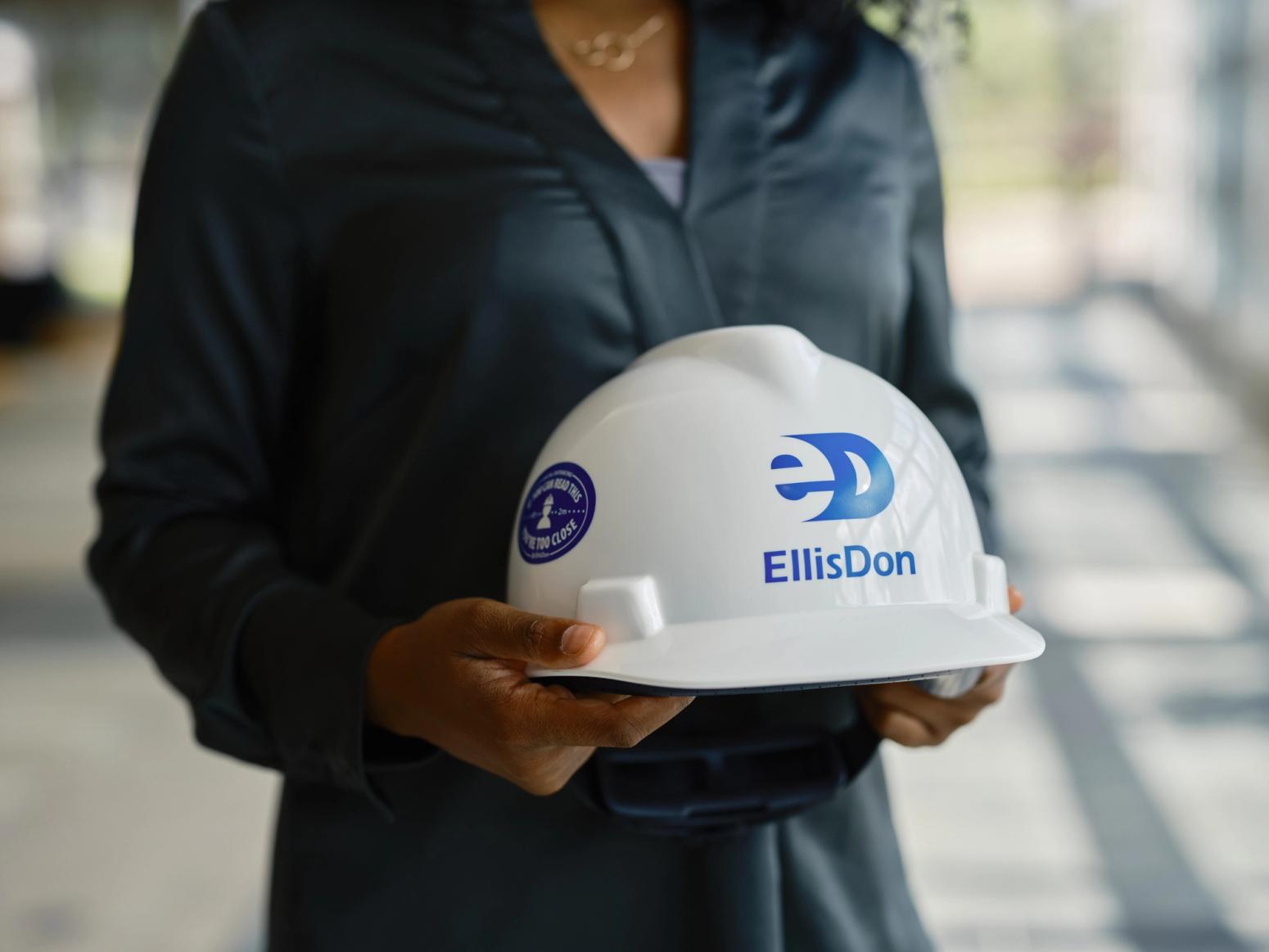 woman holding construction helmet