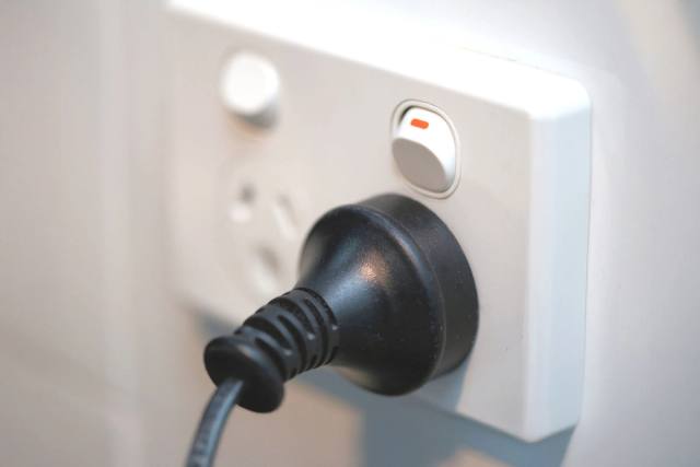 A Voltpro electrician diagnosing and repairing an electrical fault.