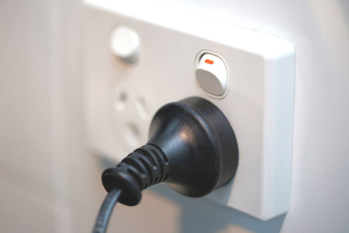A Voltpro electrician diagnosing and repairing an electrical fault.