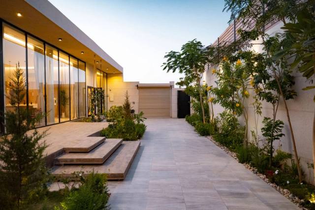 Outdoor garden and exterior lighting installed around a home.