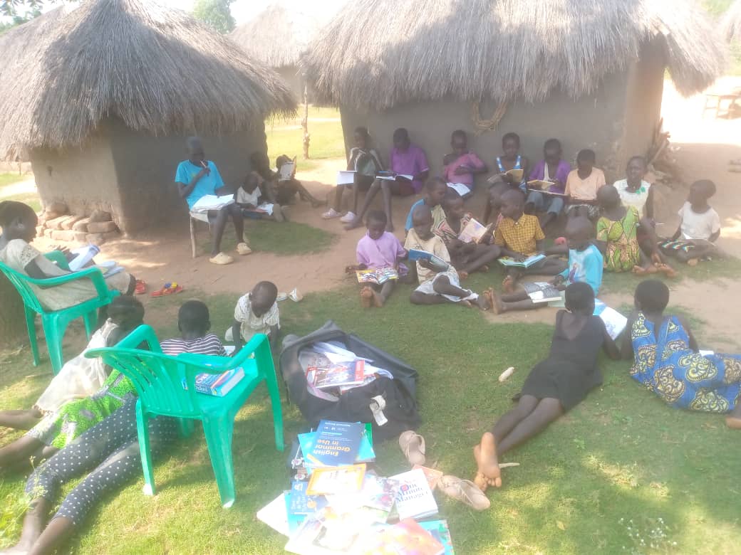oRiSS team leading a mobile library session under the trees.