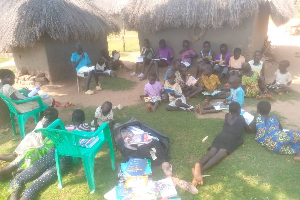 oRiSS team leading a mobile library session under the trees.