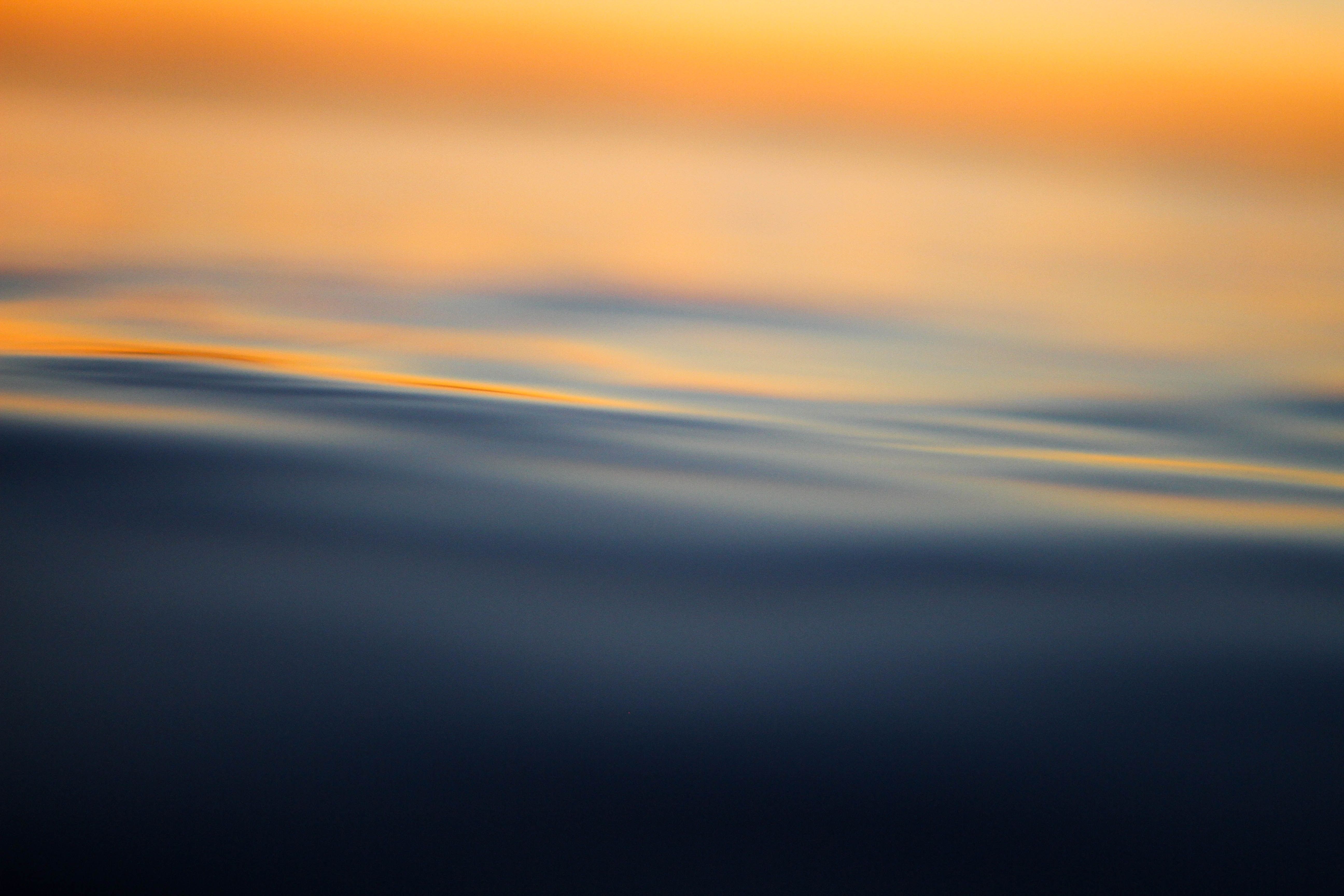 Closeup image of water with orange background 