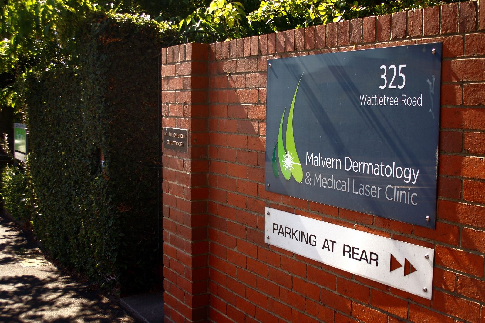 Clinic entrance gate at 325 Wattletree Road with parking at rear sign