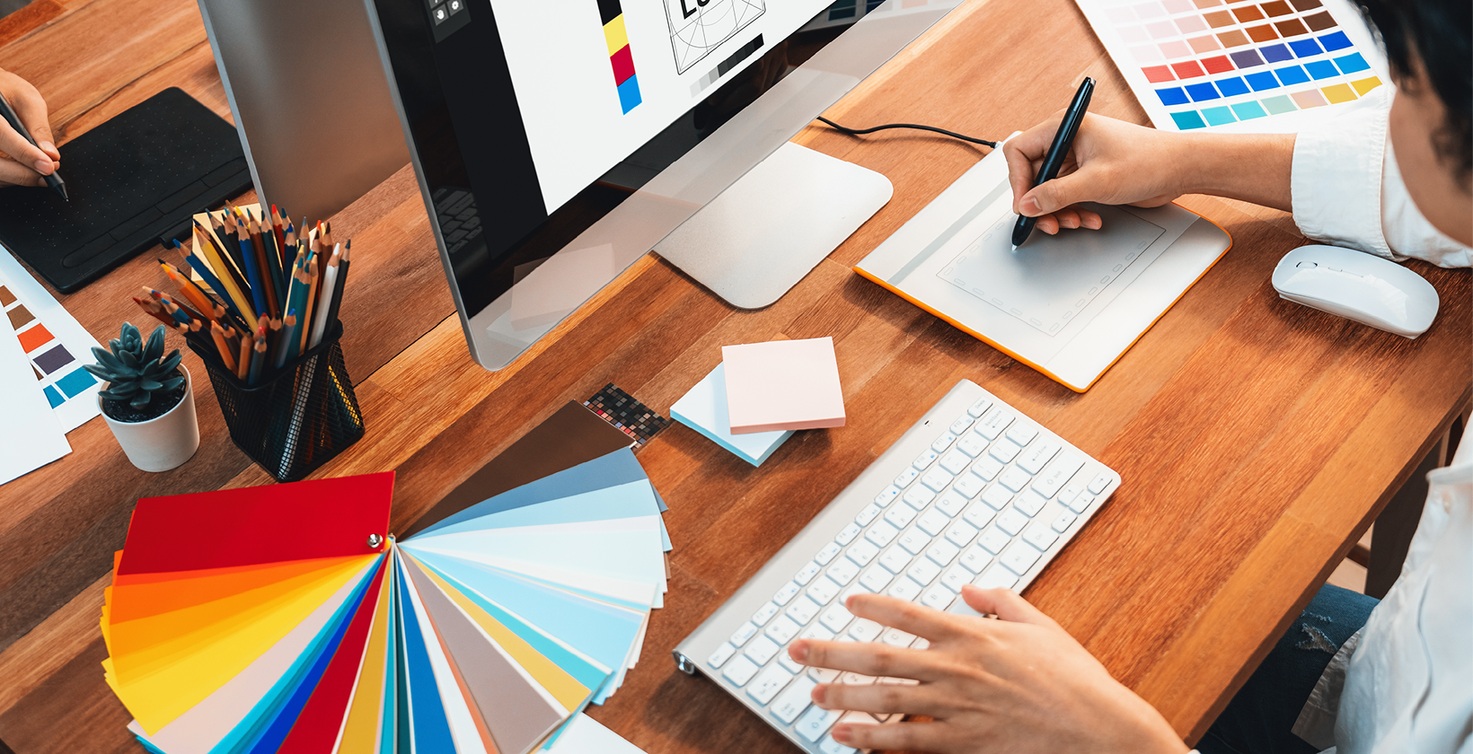 Designers using drawing tablet and colour wheel