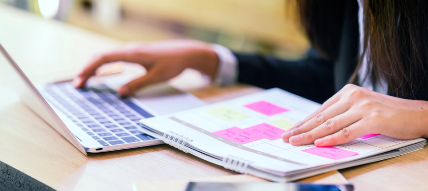Woman planning with laptop and calendar