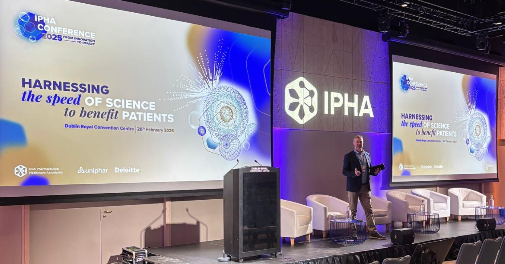 Man speaking on stage at IPHA conference