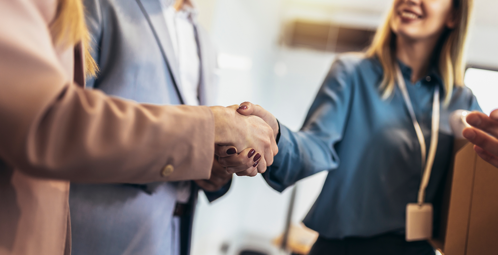 two people shaking hands in group