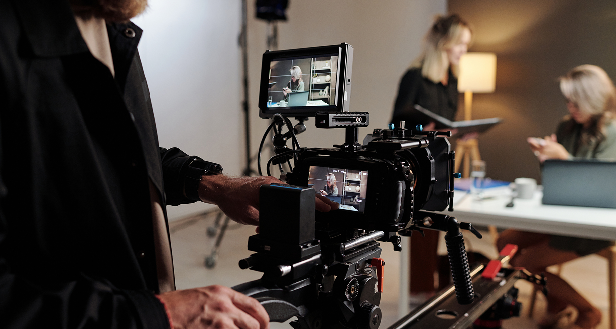 View of someone behind the camera recording two people chatting