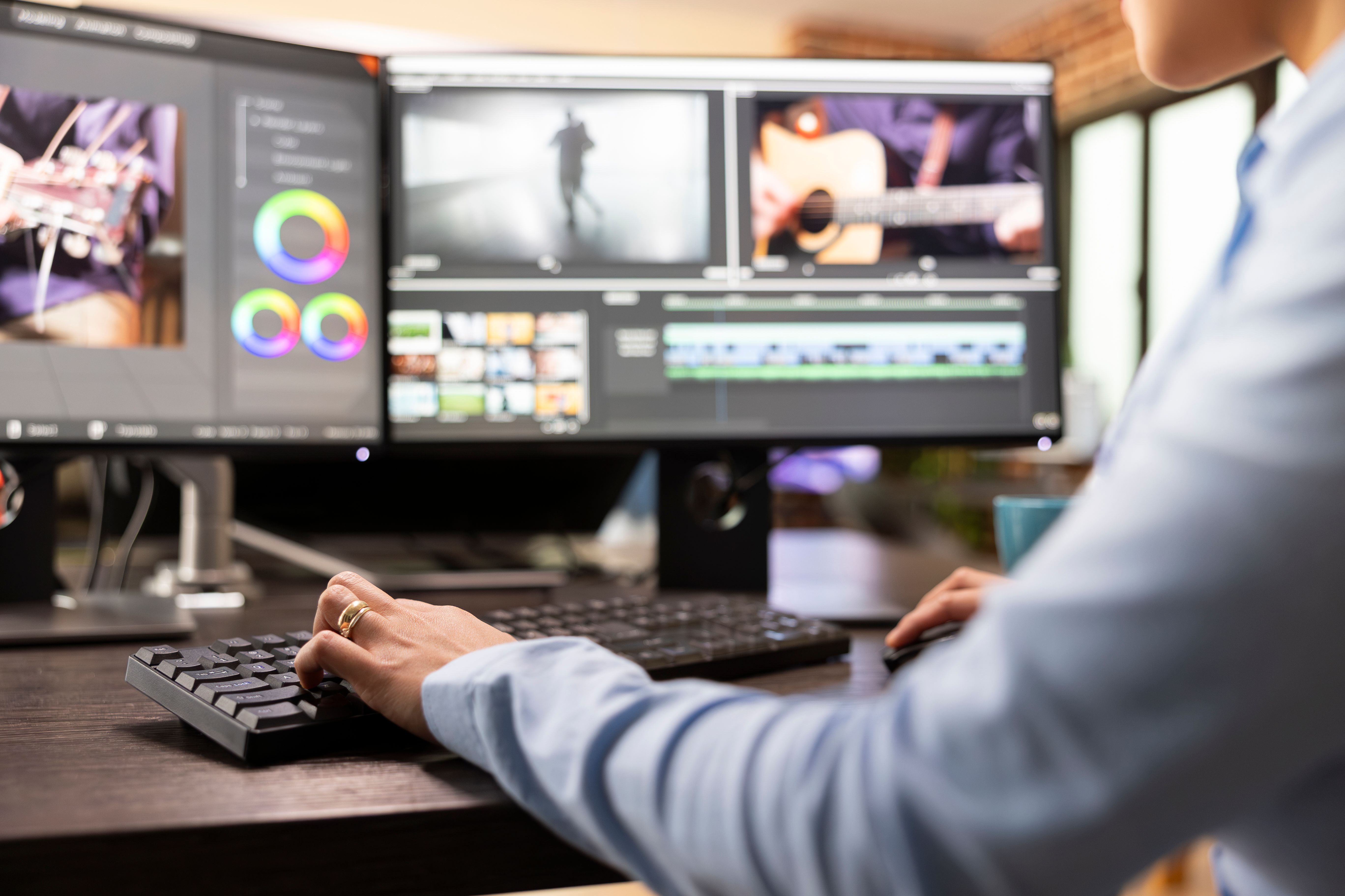 Person sitting infront of video editing software on screens