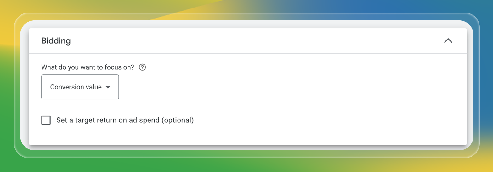 A Google Ads campaign setup panel labeled “Bidding.” It asks, “What do you want to focus on?” with a dropdown currently set to “Conversion value.” Below is an optional checkbox to “Set a target return on ad spend.” The interface sits atop a backdrop of blended yellow, green, and blue.