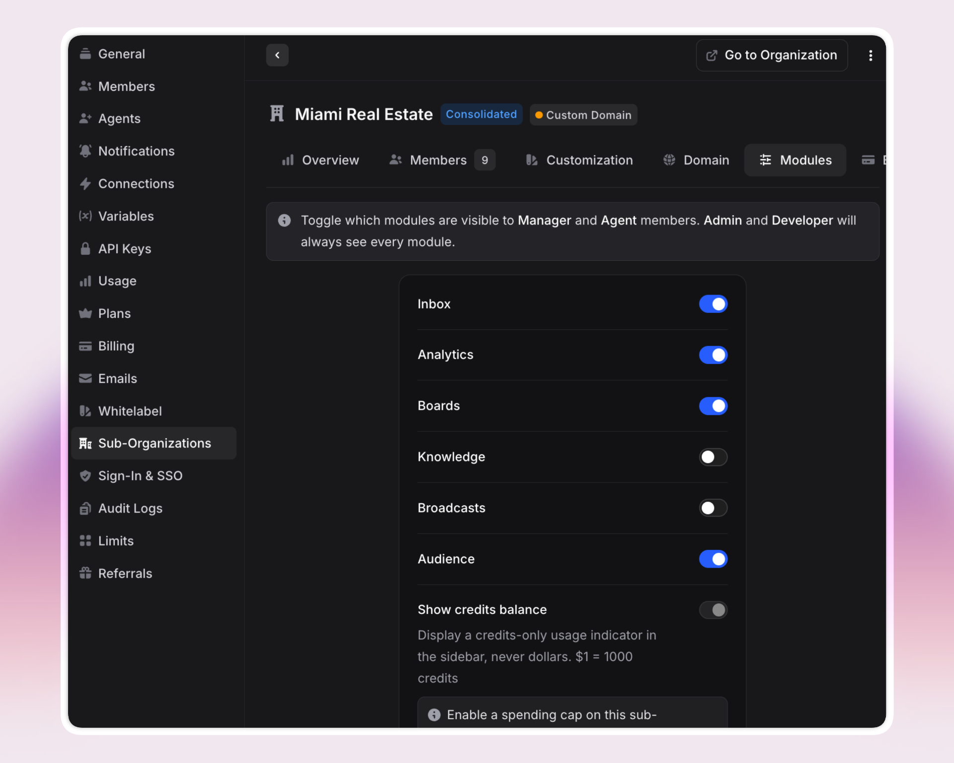 A dark-themed admin panel in Invent showing settings for the "Miami Real Estate" sub-organization. The sidebar lists admin sections like General, Members, Agents, Whitelabel, Sub-Organizations, and more. The center panel allows toggling visibility of modules (Inbox, Analytics, Boards, Knowledge, Broadcasts, Audience) for different member roles, with some toggles on and others off. Options for credits balance and spending caps are also visible.