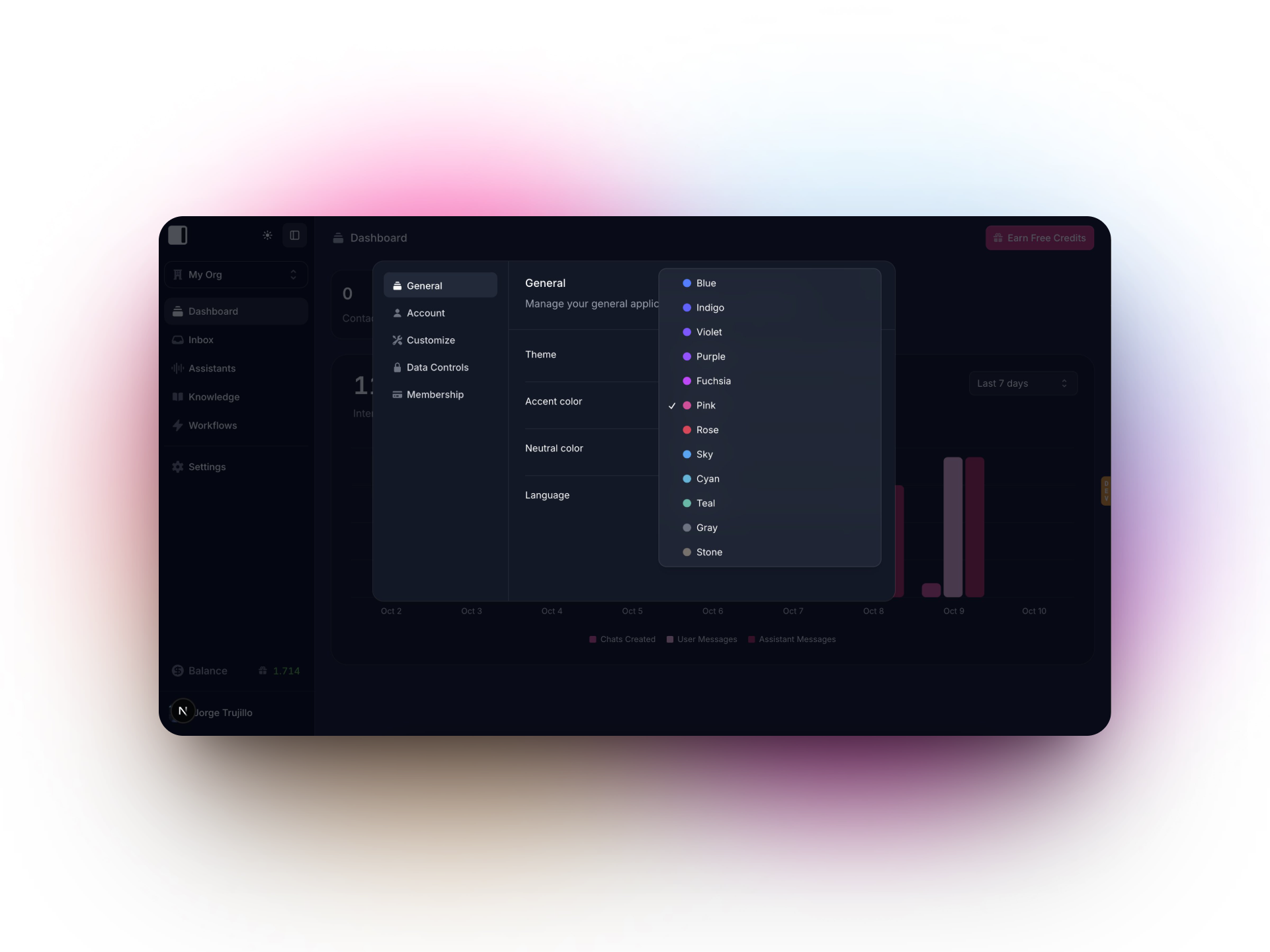 A dark-themed dashboard from Invent settings menu is open, displaying theme customization options. A dropdown menu lists various accent color choices such as blue, indigo, violet, fuchsia, pink, rose, and more. The blurred pink and white background highlights the customization panel, while dashboard analytics and navigation are visible behind the menu.