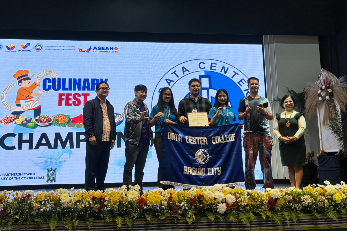 DCCP delegates hold a Data Center College of the Philippines, Baguio City banner and a certificate on stage below a Culinary Fest Champion screen.
