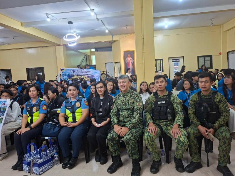 Uniformed police and military personnel seated in the front row with hundreds of students behind them during the seminar at the DCCP Annex Building