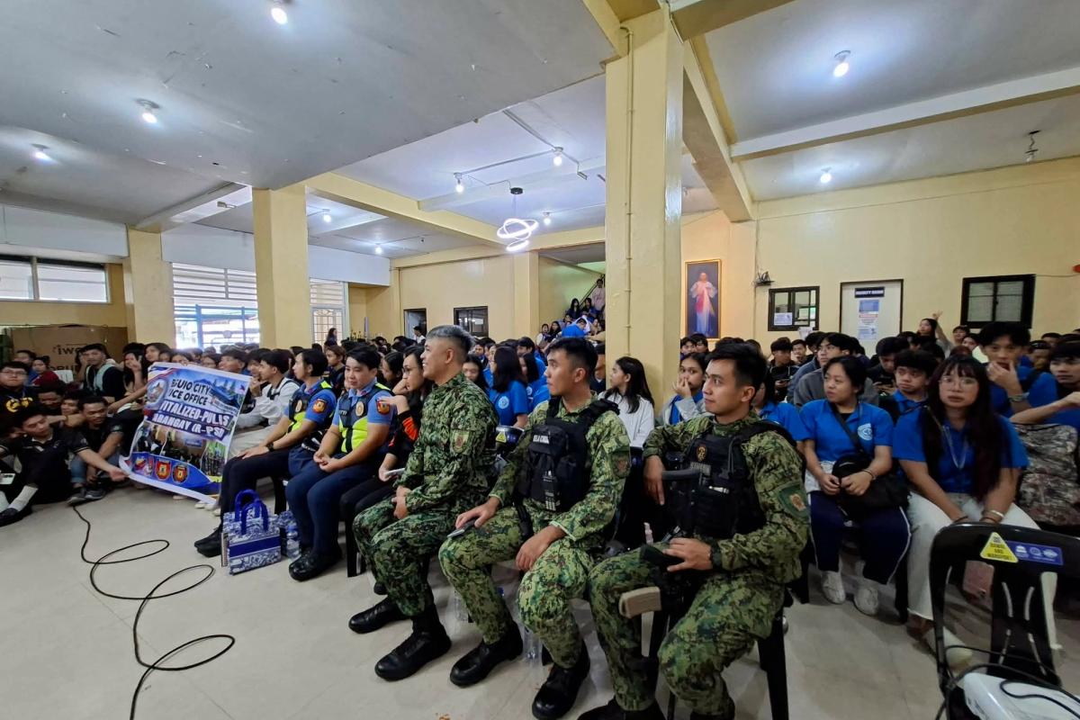 Students and uniformed personnel seated on the floor of the DCCP Annex Building hall during the firearm and school safety seminar
