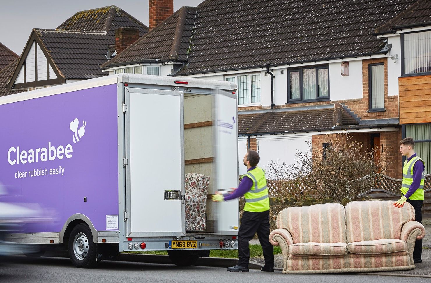 operatives loading sofa onto a van
