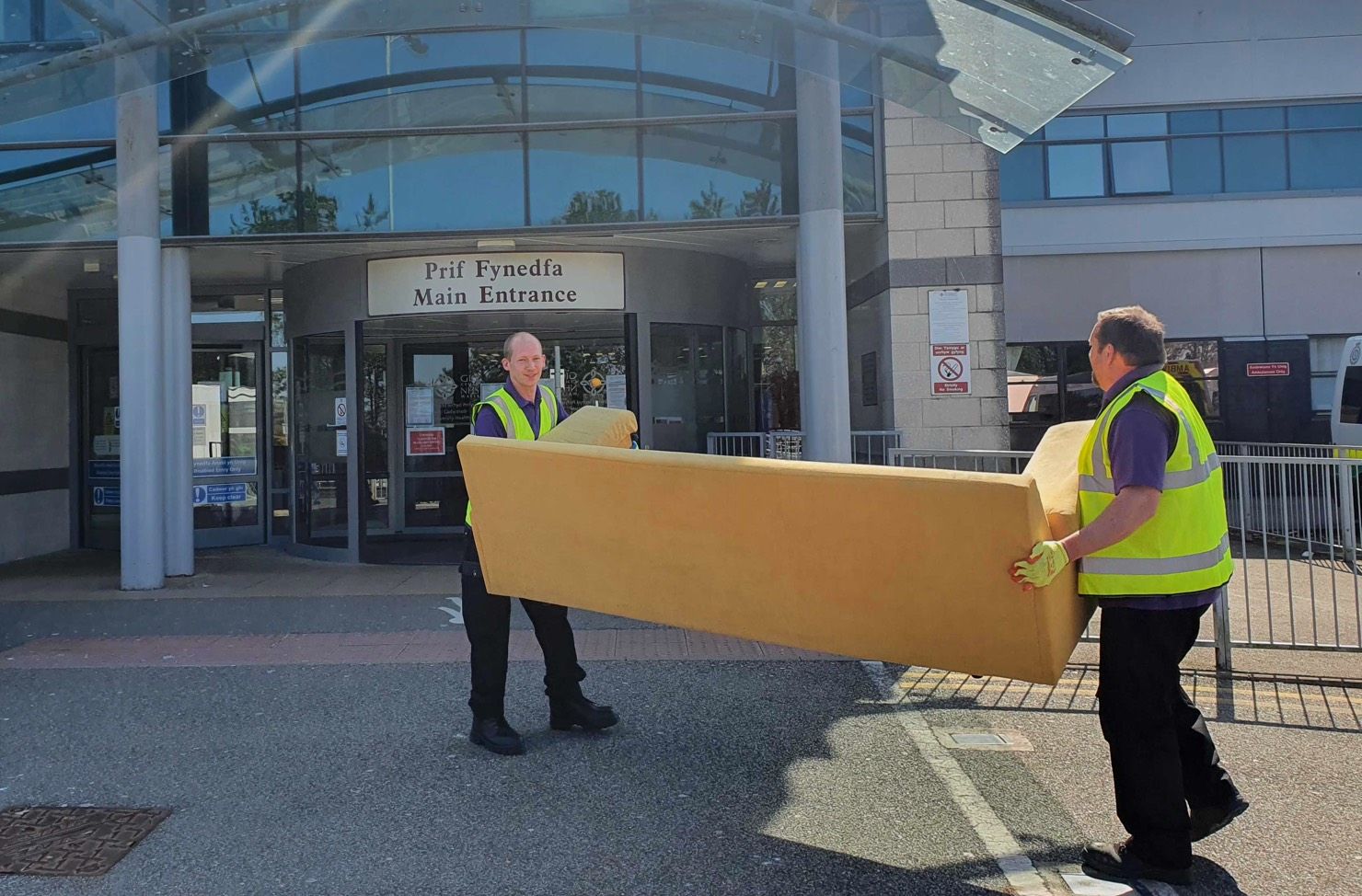 operatives carying a sofa