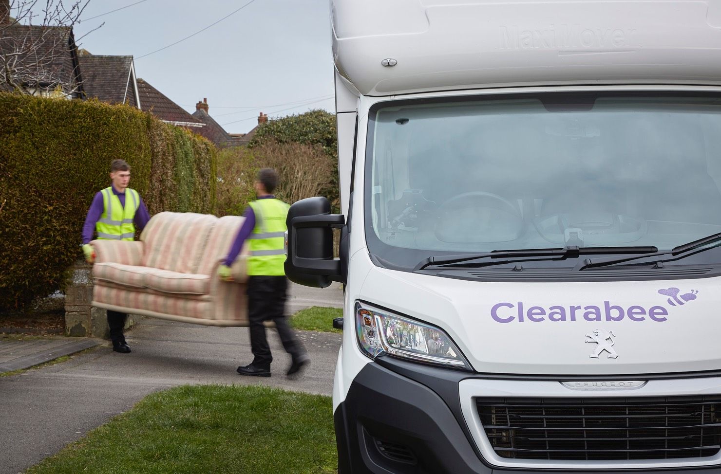 operatives carrying waste to a van
