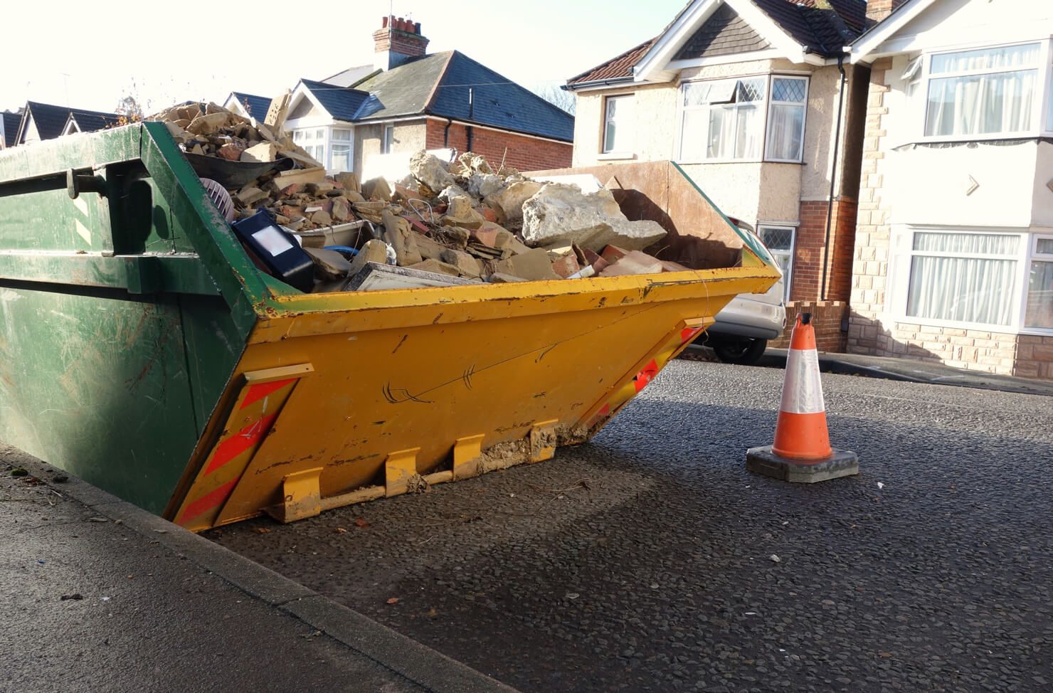 skip on the road with a cone