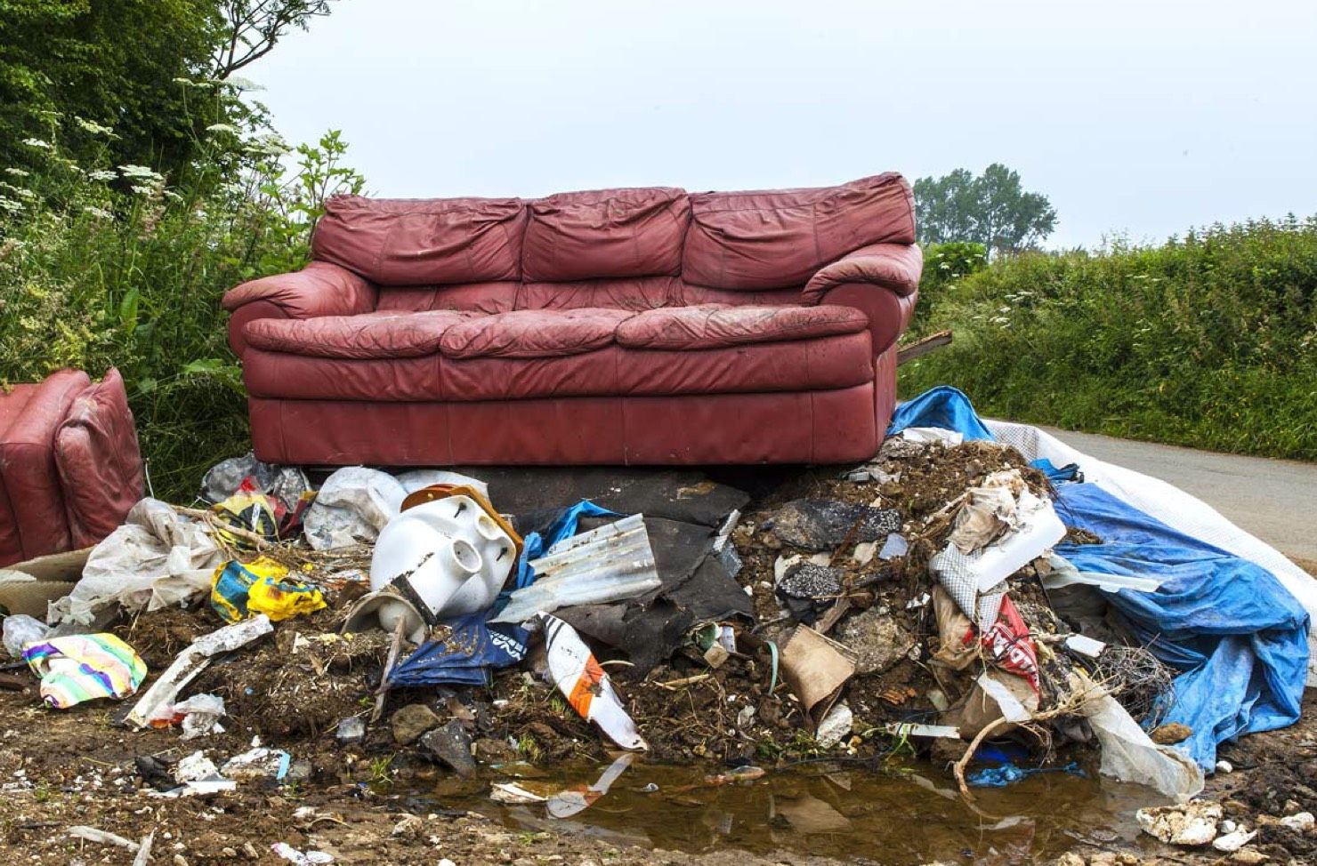 fly tipped waste by a road