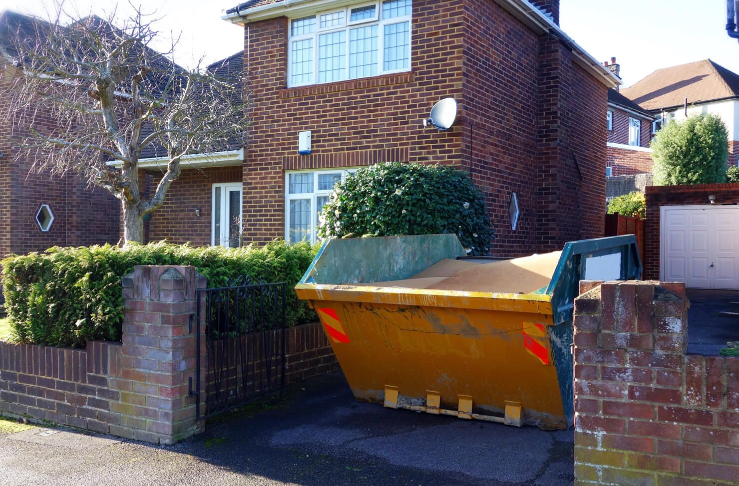skip hire price - skip on a driveway