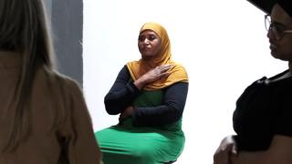 FGM survivor sat in front of photography screen