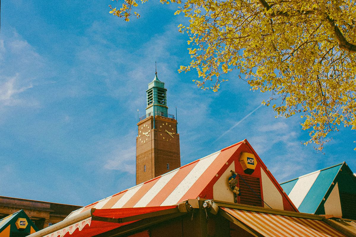 Rooftops of Norwich markets with a clock tower in the background