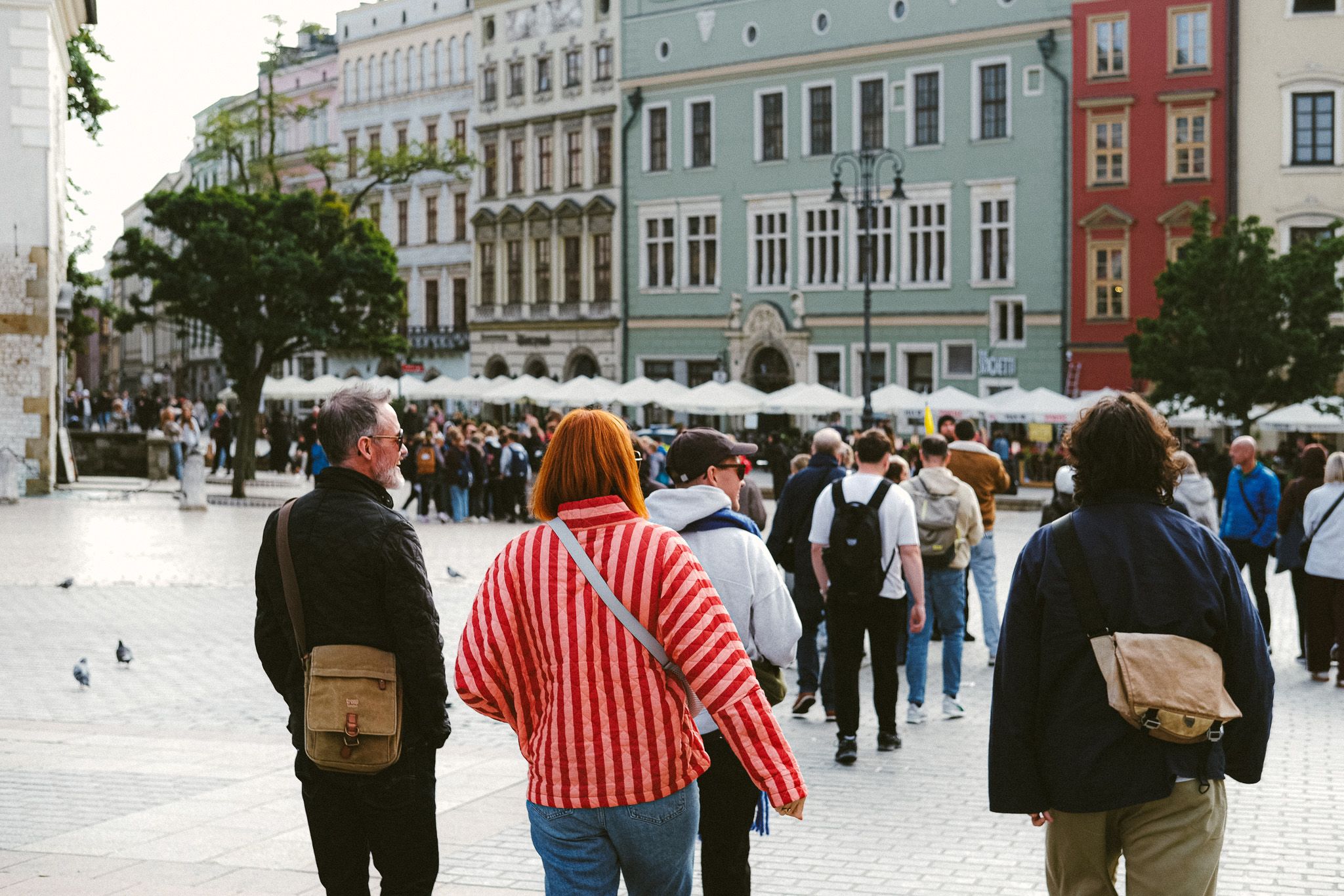 Team walking across Krakow Old Town square