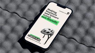 Mobile phone reading 'Making business and leisure travel eco-friendly'