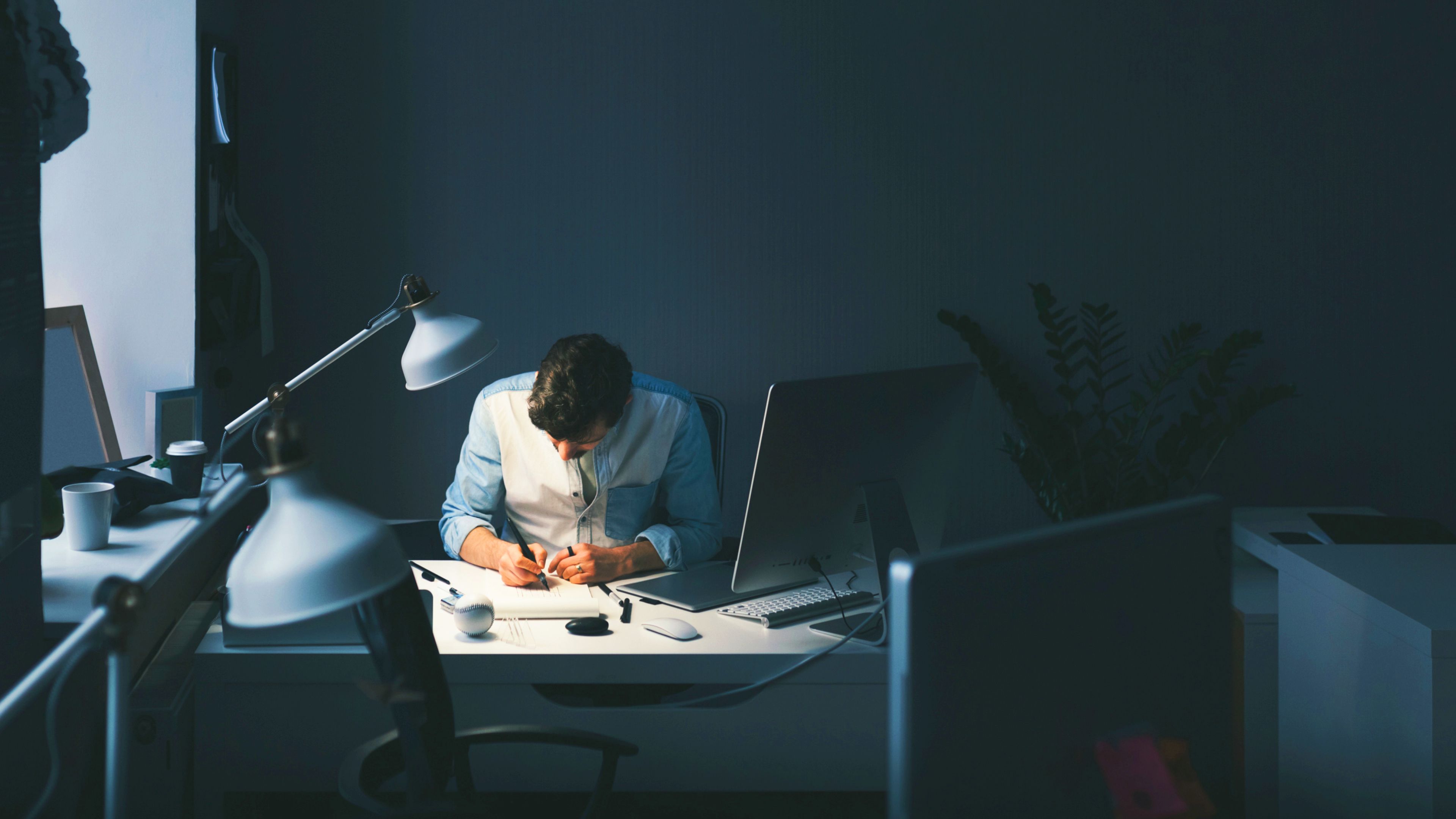 man working behind a desk