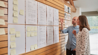 Staff looking at designs on the wall