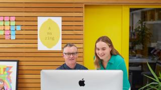 Two people working at a computer