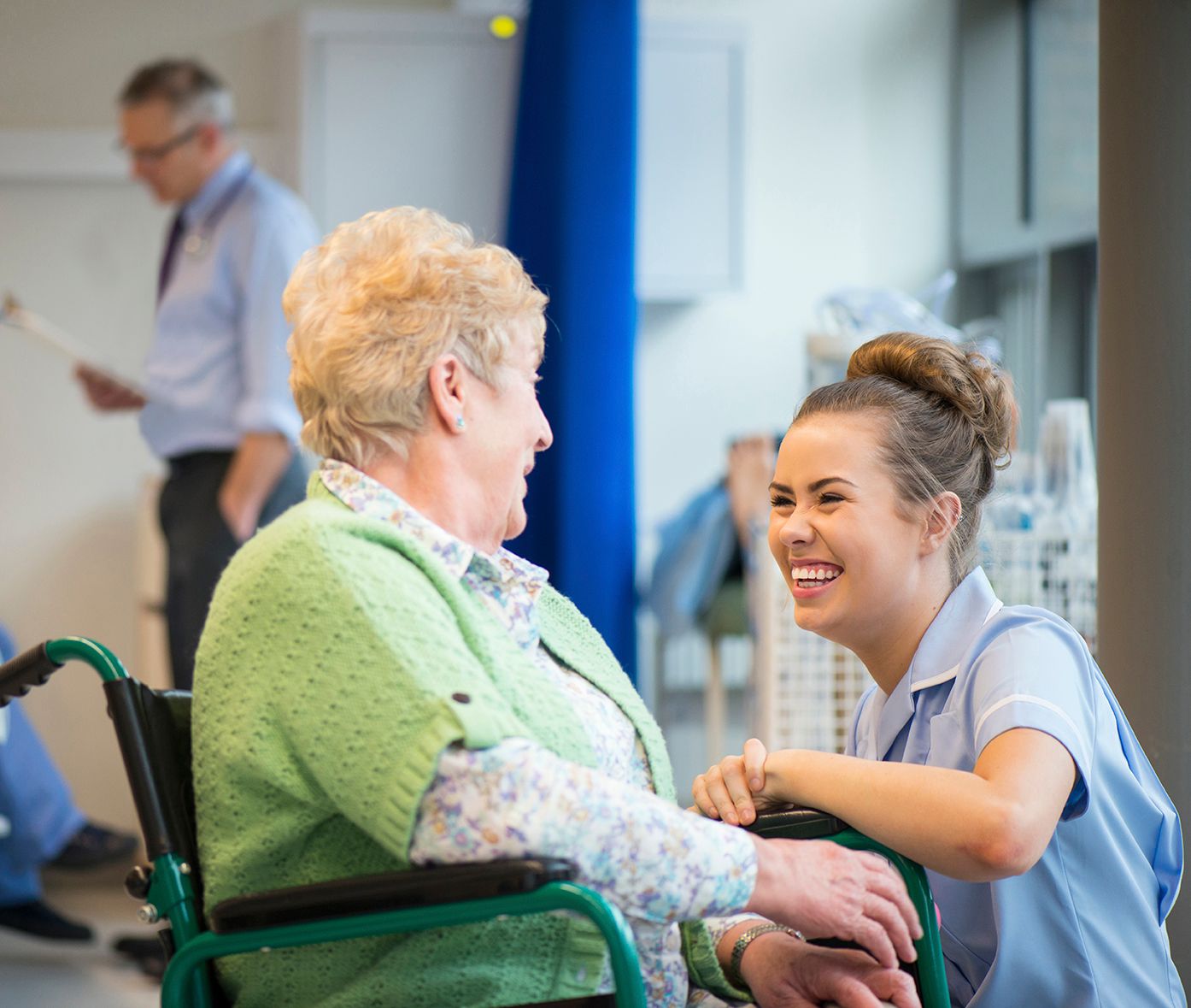 Nurse talking to person in wheelchair
