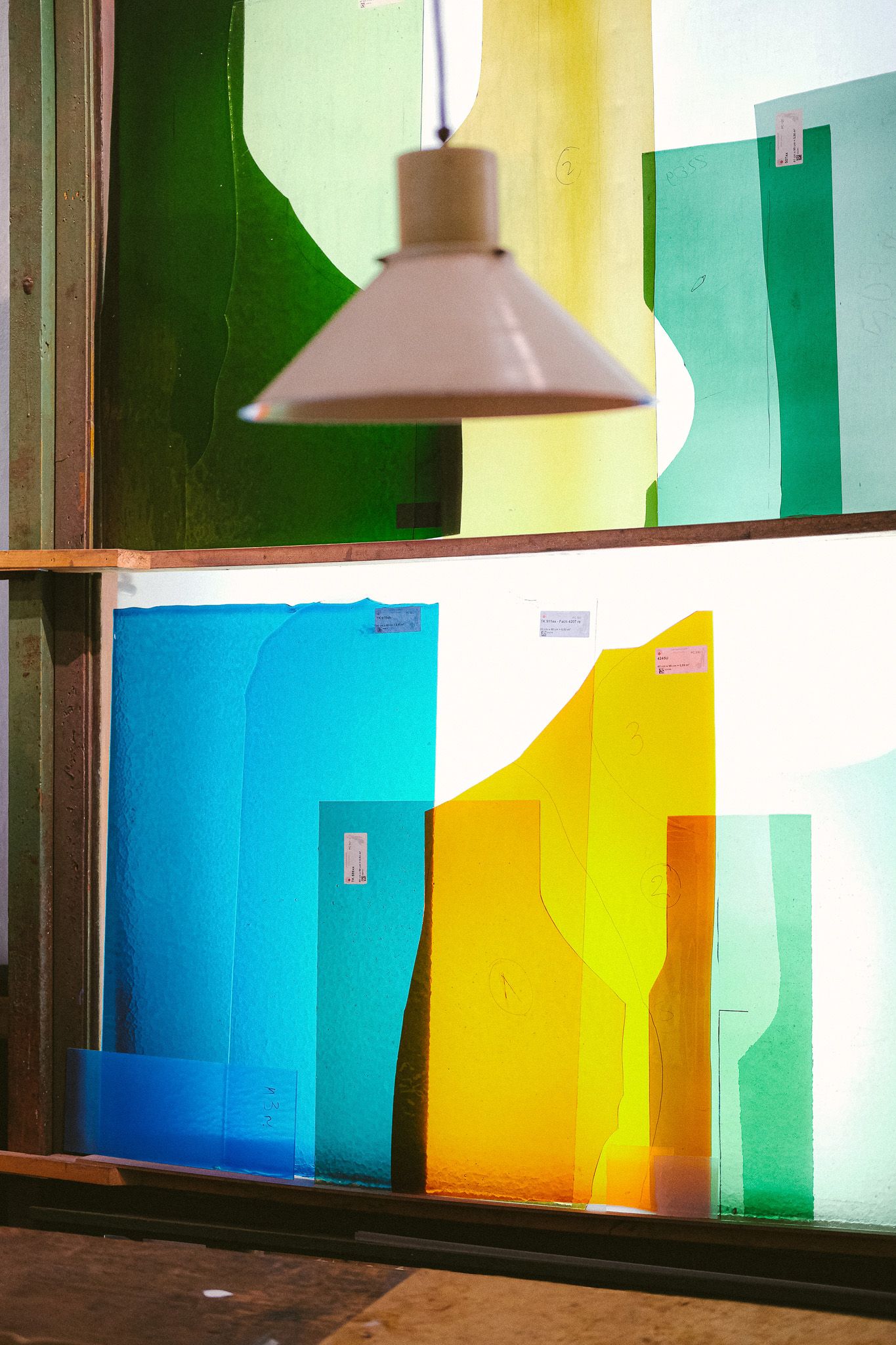 Large panels of stained glass on a shelf