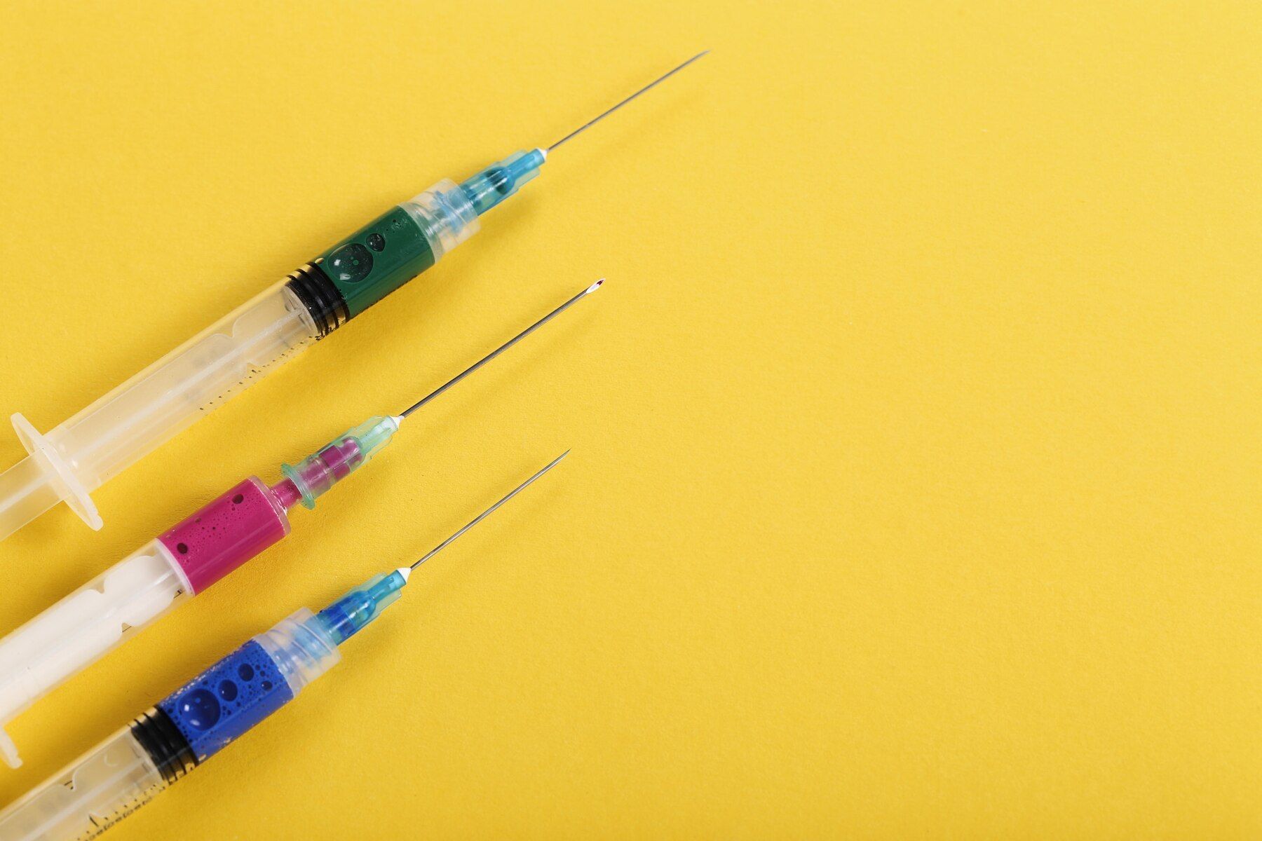 Yellow Background with three syringes
