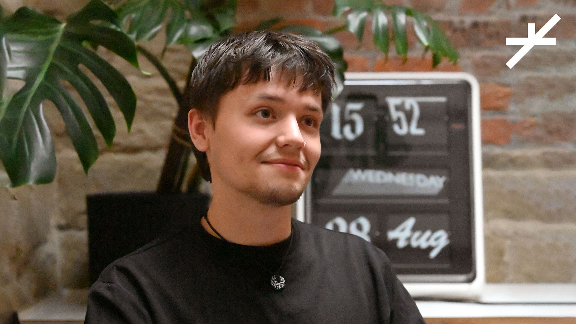 image of person in the centre with a clock and plant in the background