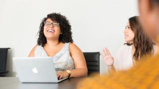 Employees around table talking