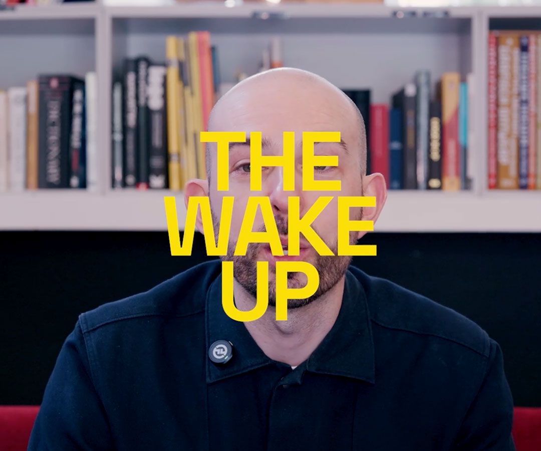 The Wake Up text over an image of Chris sat in the studio