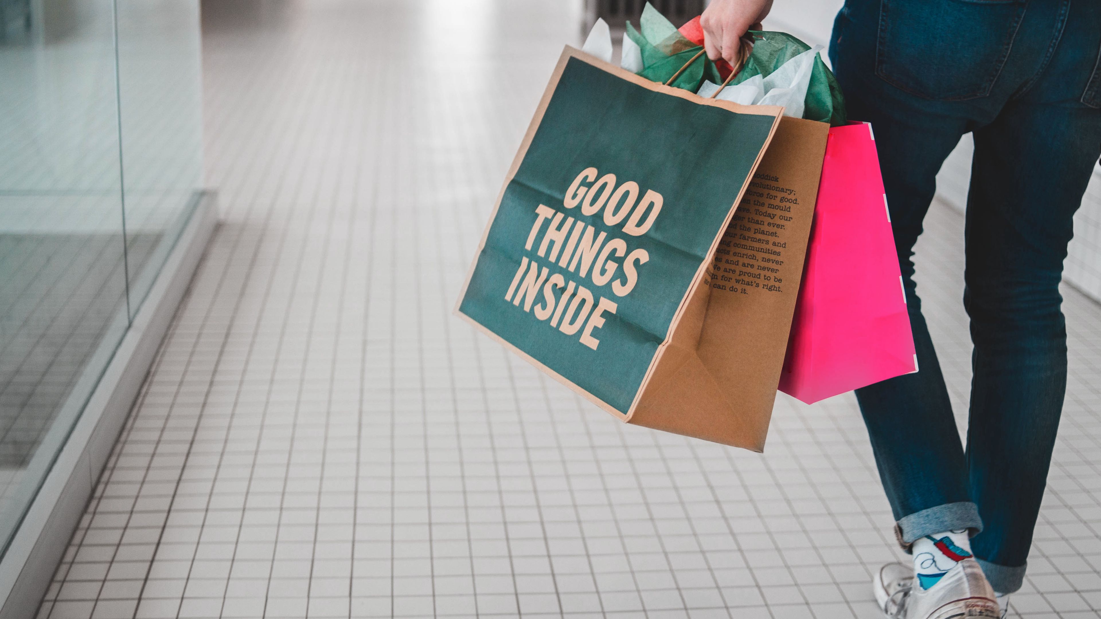 Man with bags walking in a shopping centre