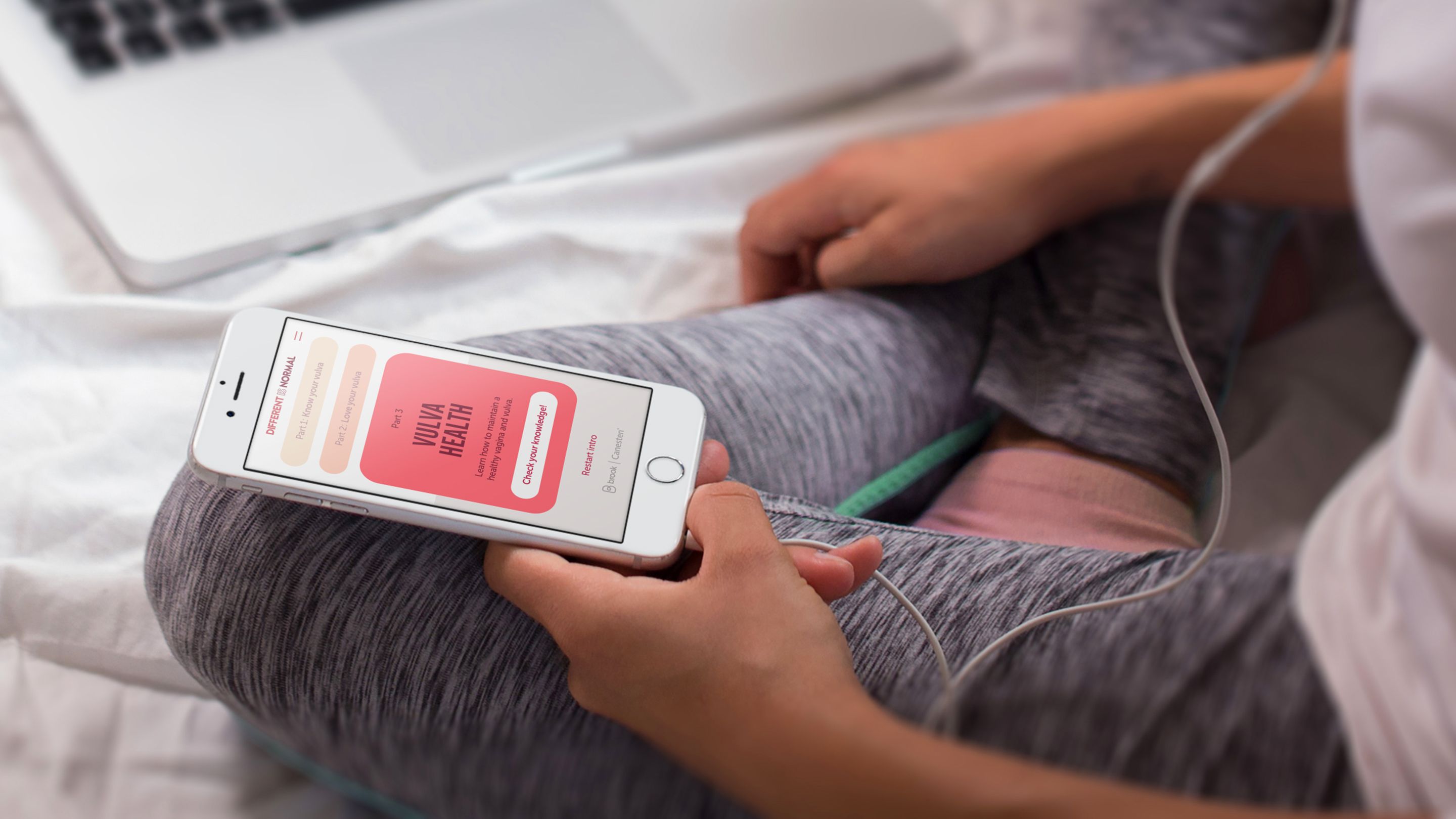 Woman holding iPhone using the vulva app
