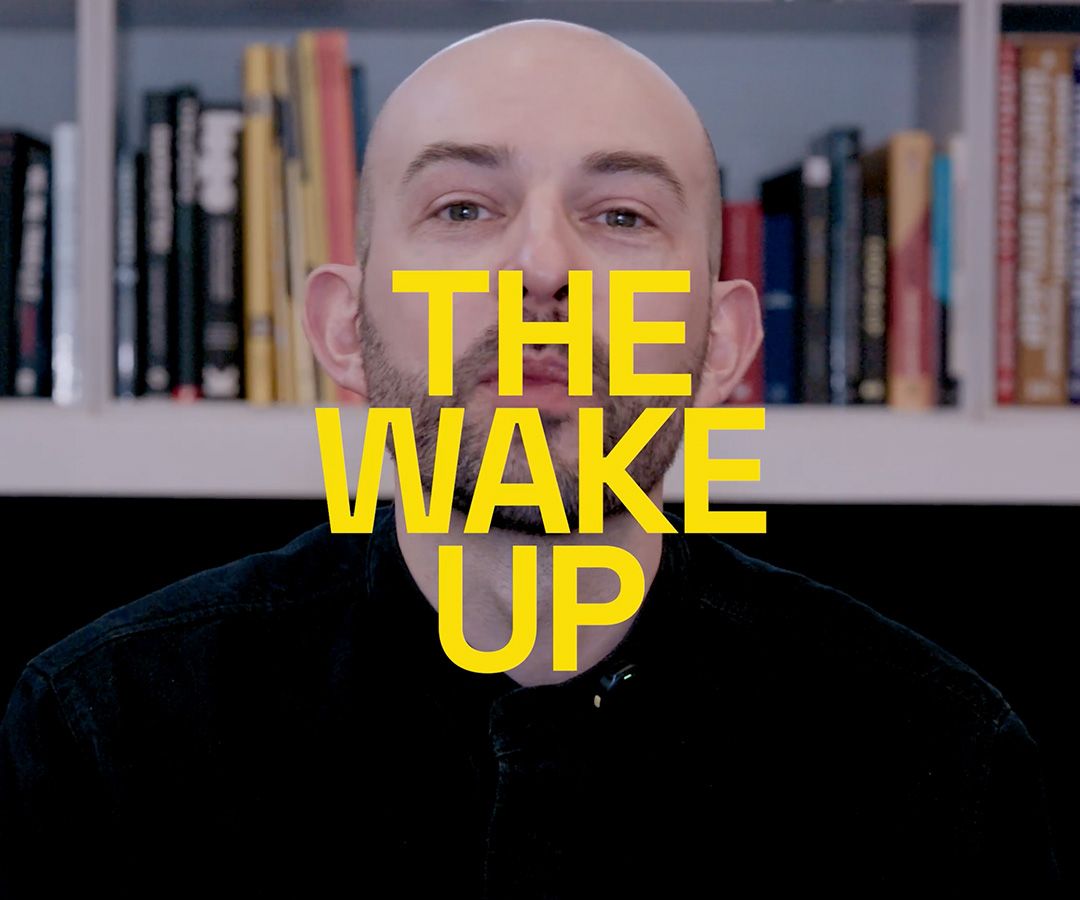 The Wake Up text over an image of Chris sat in the studio