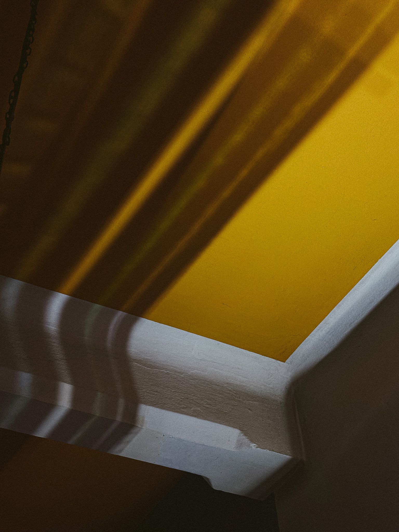 Long shadows detail across yellow surface