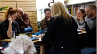 Group of people chatting at the table in an office setting