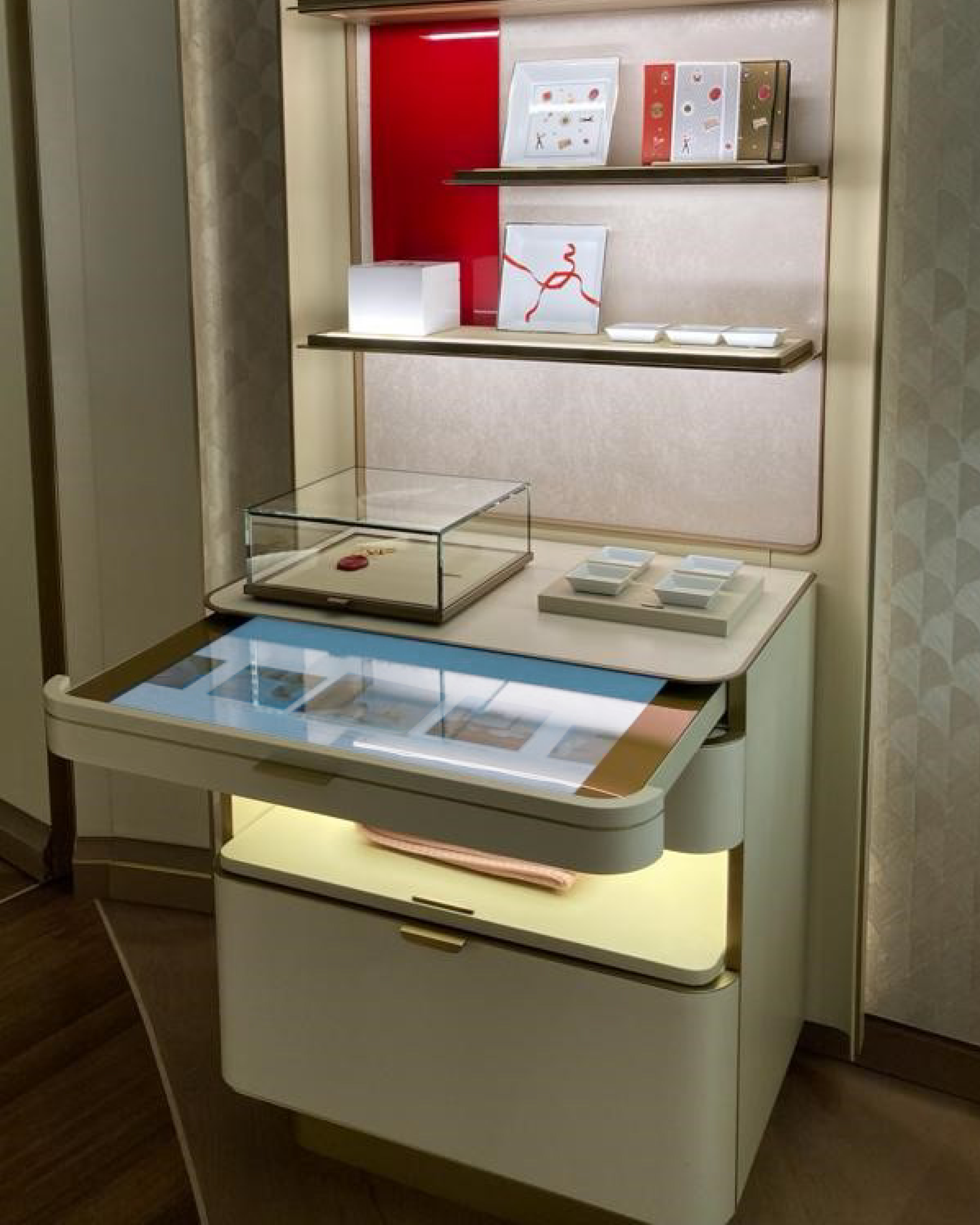 Touch display built into a boutique table, under a jewellery vitrine