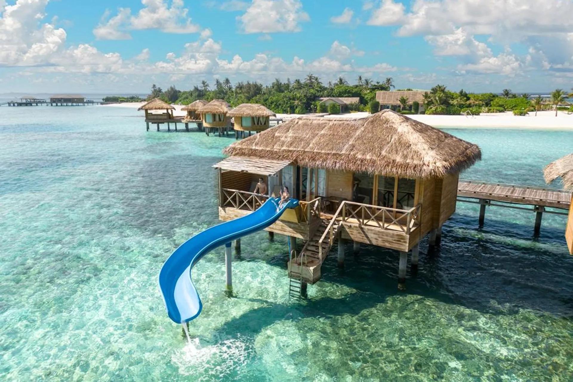 An Aqua Suite with Slide at You & Me Maldives, an overwater villa built around a private water slide