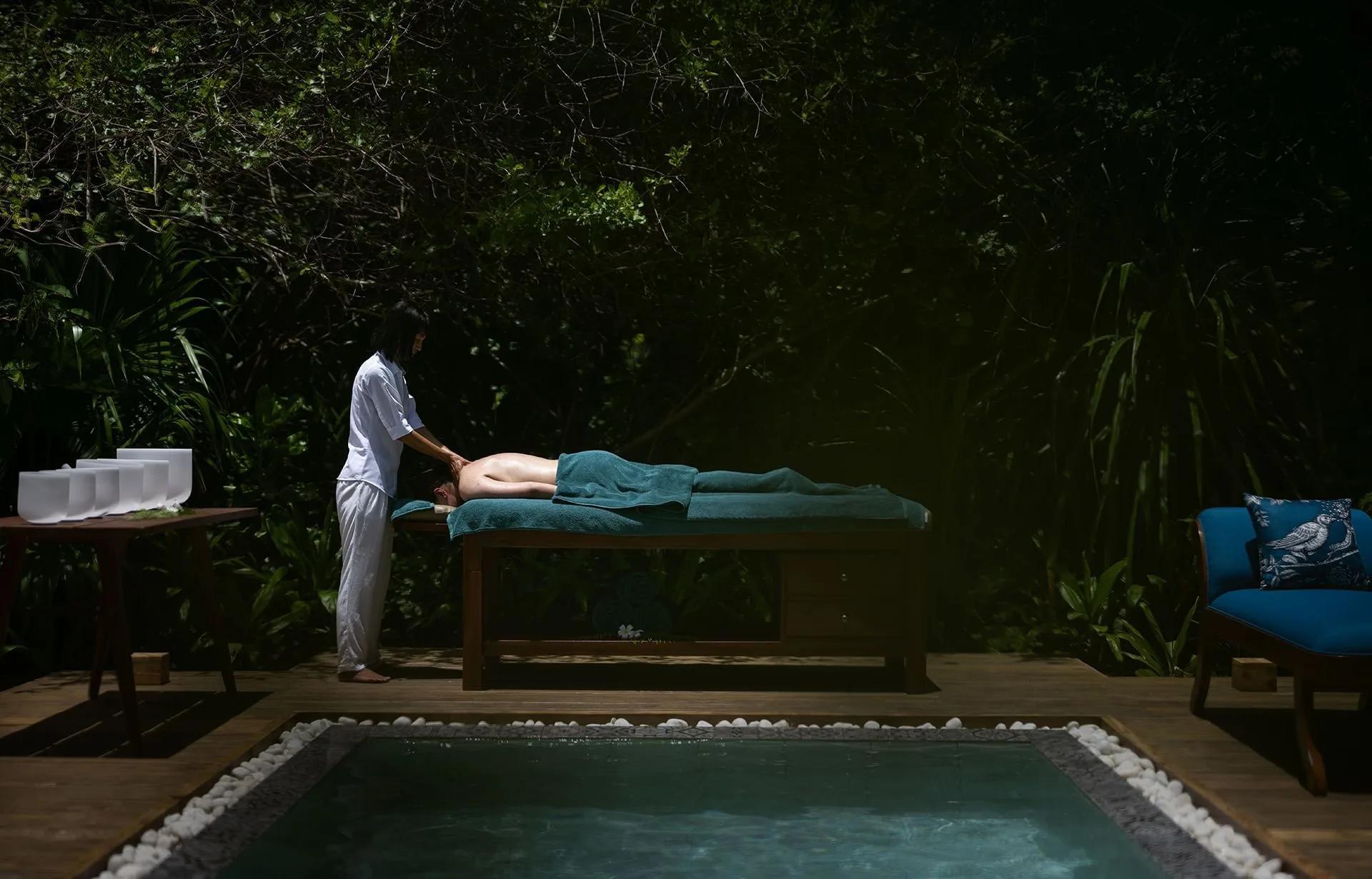 A guest receiving an outdoor massage treatment at Xanadu Spa, Ifuru Island Maldives