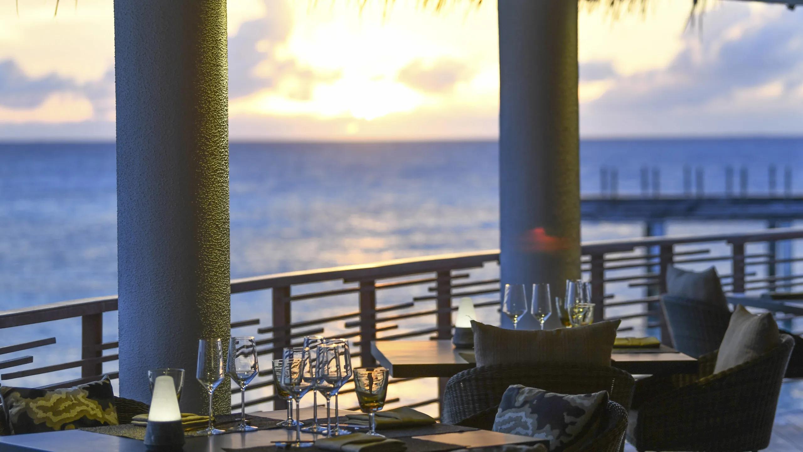 The dining room at Shio, with its open kitchen and beamed ceiling overlooking the water