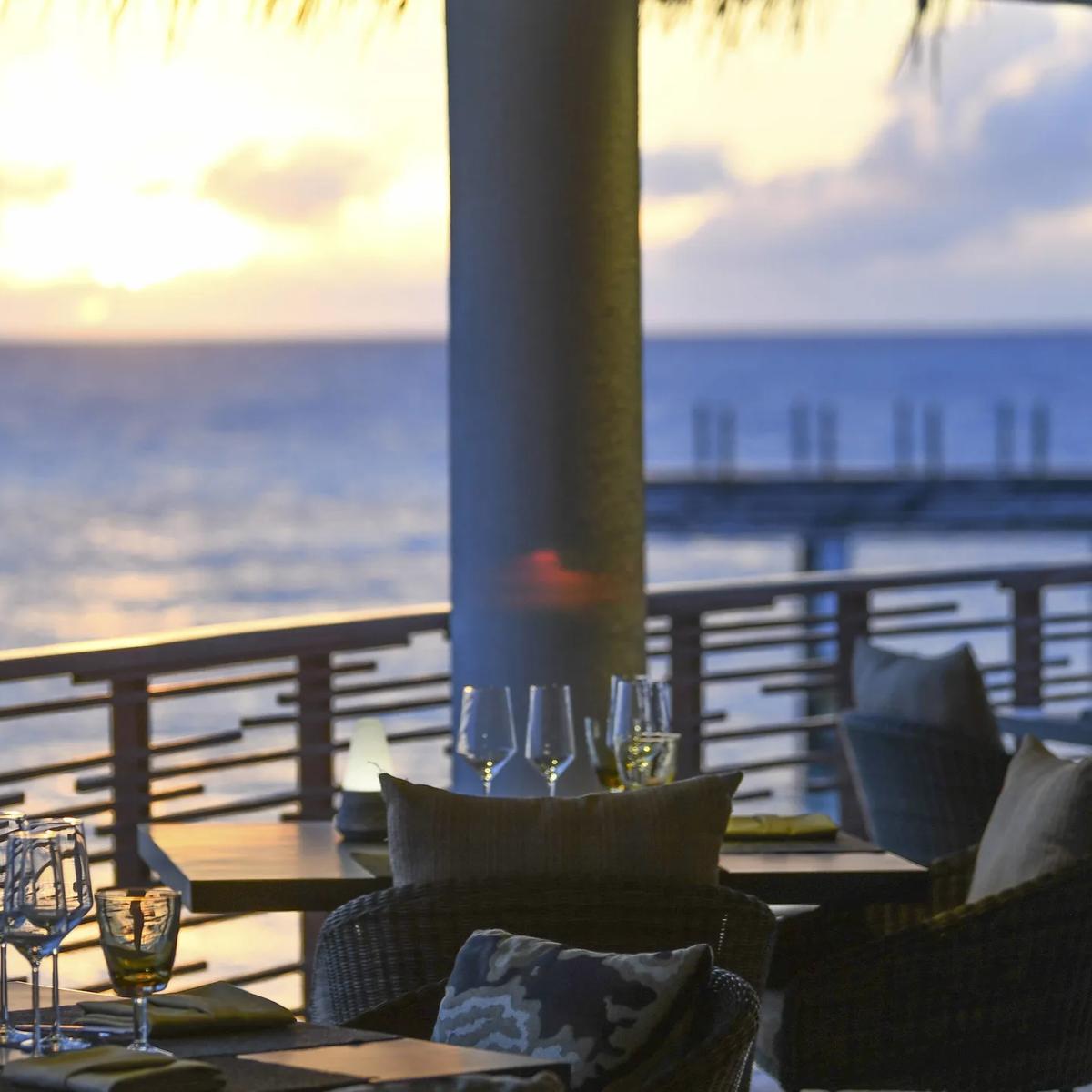 The dining room at Shio, with its open kitchen and beamed ceiling overlooking the water